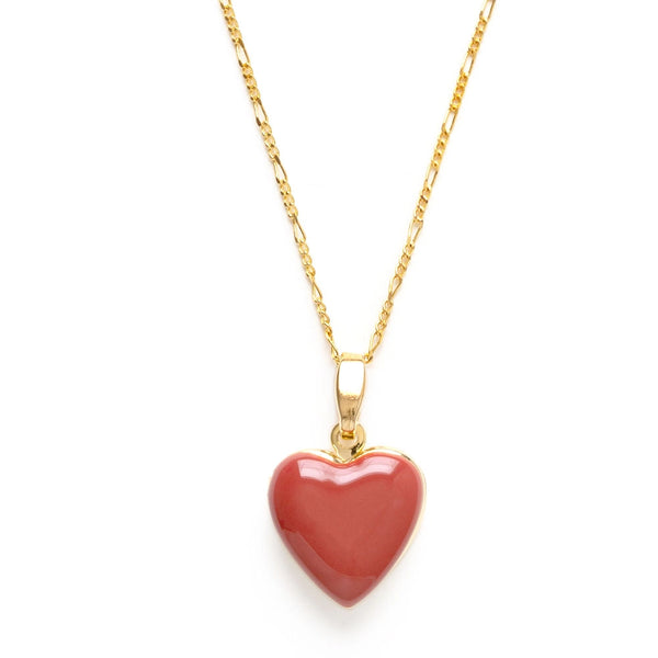 Gold necklace with a red heart pendant on a white background