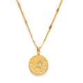 Gold necklace with a round pendant on a white background