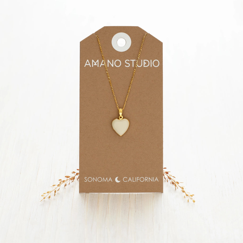 white heart necklace against a cardstock 