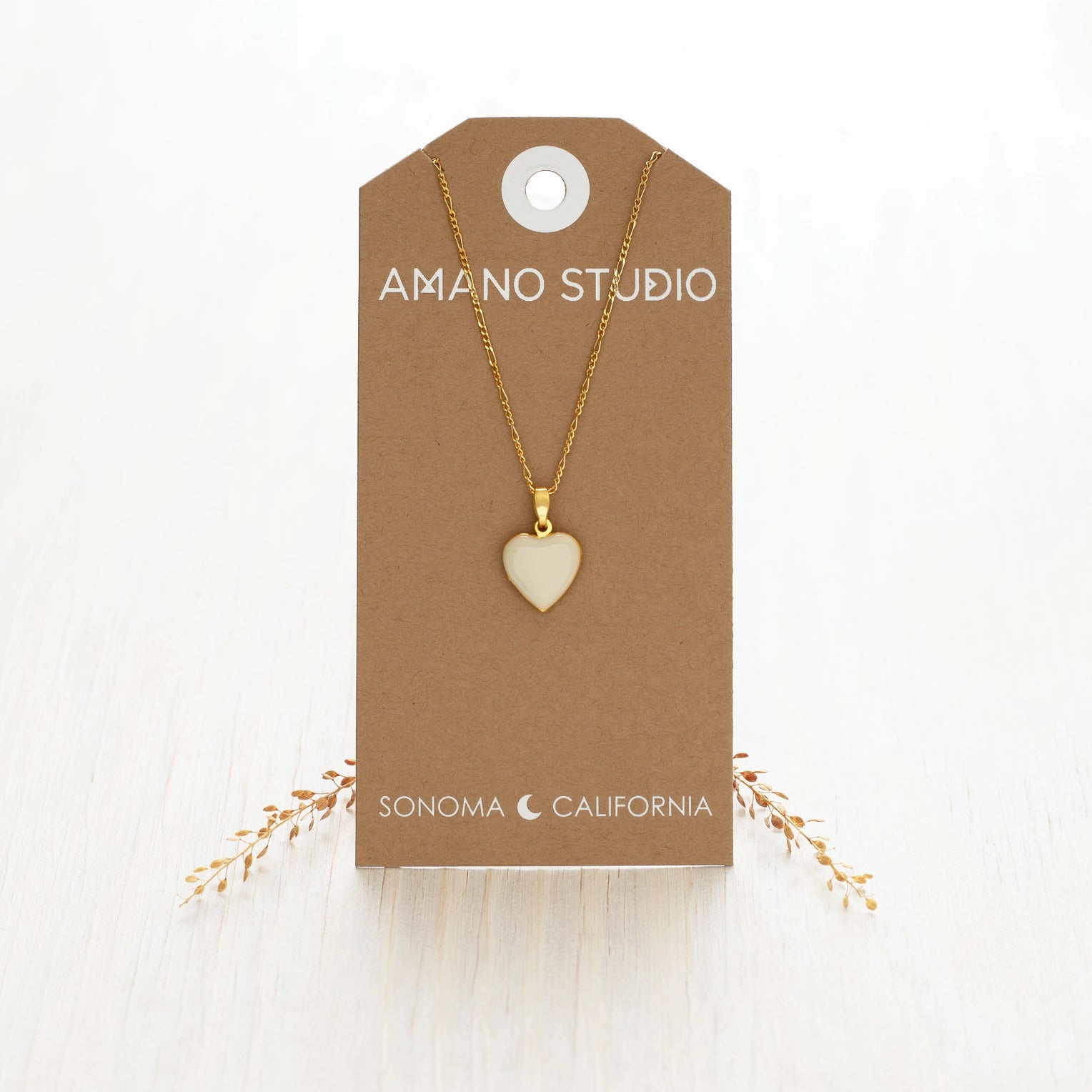 white heart necklace against a cardstock 