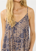 Woman wearing a blue and beige patterned dress on a white background