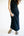 Person wearing a black ribbed knit skirt on a white background