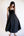 Woman wearing a black sleeveless dress against a white background