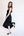 Woman wearing a black sleeveless dress on a white background
