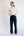 Woman wearing a cream sweater and black pants with white stripes on a white background