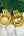 Gold hoop earrings on white stones with a green leaf background