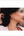 Woman wearing gold hoop earrings with a blurred natural background