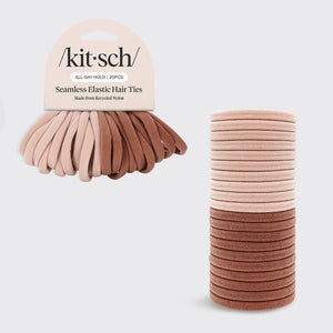 A pack of Kitsch Seamless Elastic Hair Ties shown on a light gray background, with the retail header card visible on the left and two stacks of hair ties on the right. The hair ties come in soft neutral shades including blush pink, beige, tan, and medium brown.