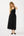 Woman wearing a black dress on a white background