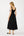 Woman wearing a black sleeveless dress on a white background