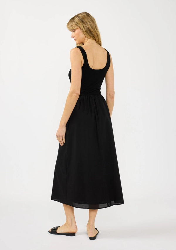 Woman wearing a black sleeveless dress on a white background