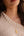woman with gold necklace and beige sweater