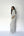 A woman with long dark hair stands in profile against a plain white studio background, wearing a loose white top and matching wide-leg pants with thin dark horizontal stripes.