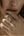 Close-up of a hand with gold rings on a blurred background